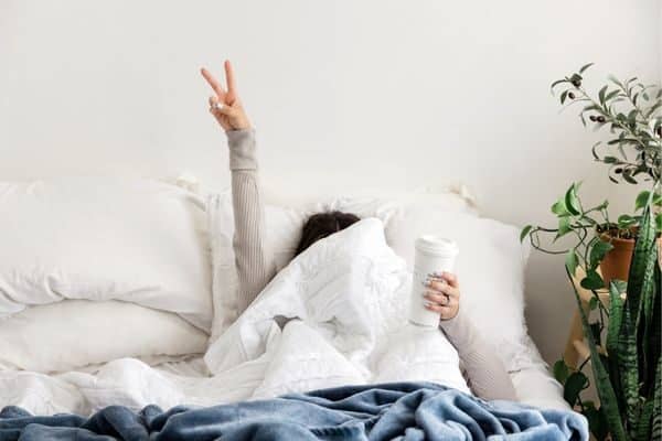 woman in bed with a coffee