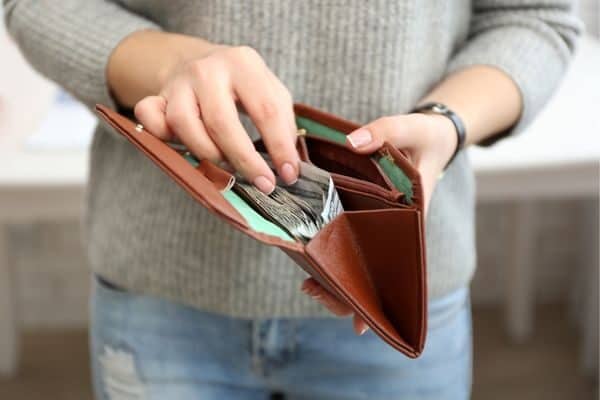 woman getting money out of a wallet