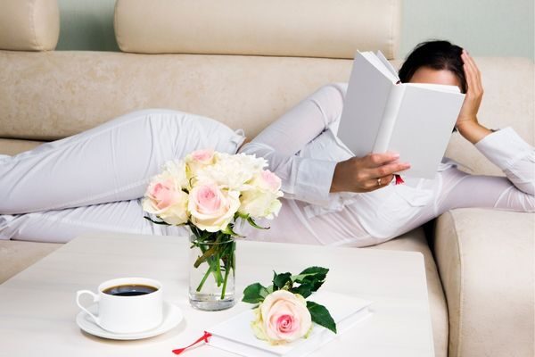 woman reading a book on the couch