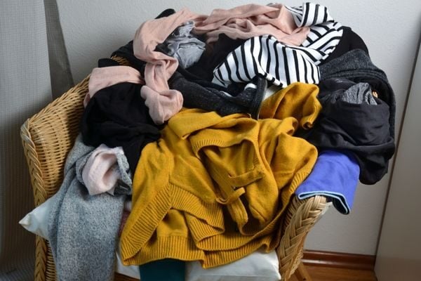 clothes piled on chair : where to start when decluttering