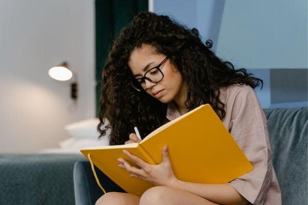 woman writing in journal