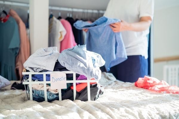 woman sorting clothes bedroom closet list