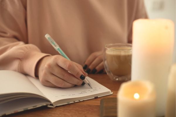 woman journaling her limiting beliefs about money and success