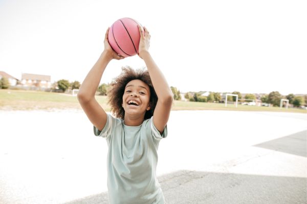 boy playing basketball, cash envelope categories examples for beginners