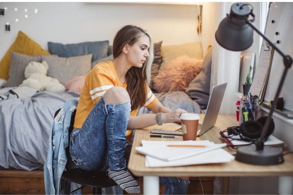 teen working on her computer at her desk