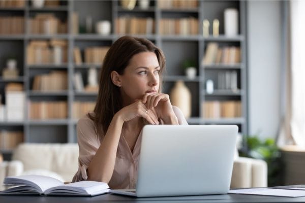 woman sitting and looking at computer