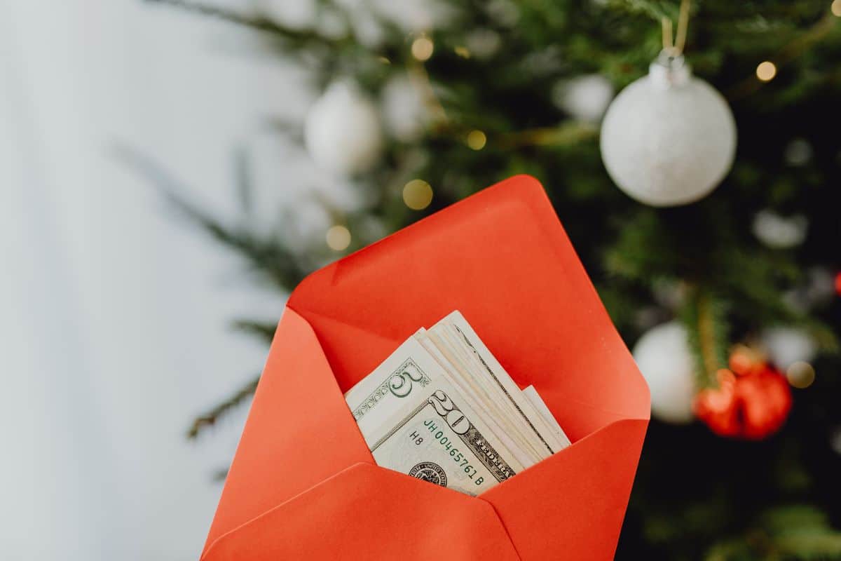 cash in Christmas envelope for savings challenge chart