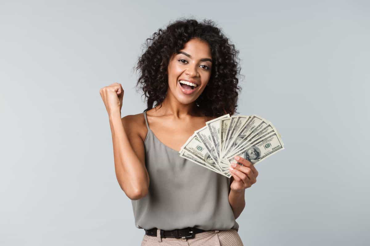 woman holding cash: liquid net worth meaning questions