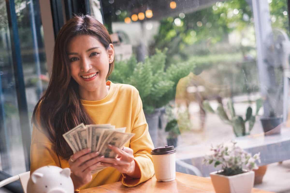 woman with money from following through on her commitment card