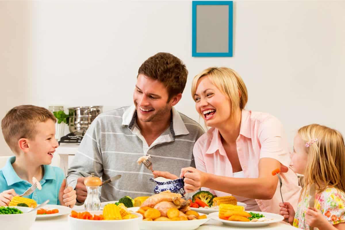 family of four eating dinner at the table