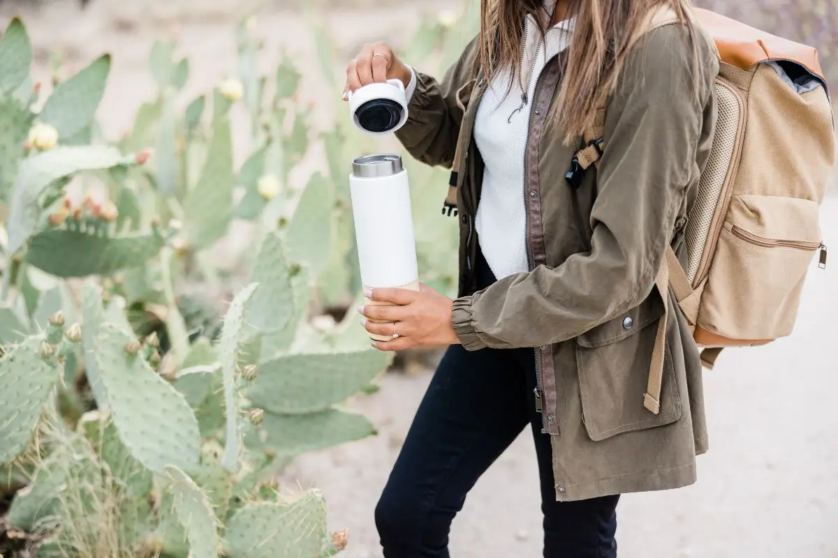woman holding a cup outside
