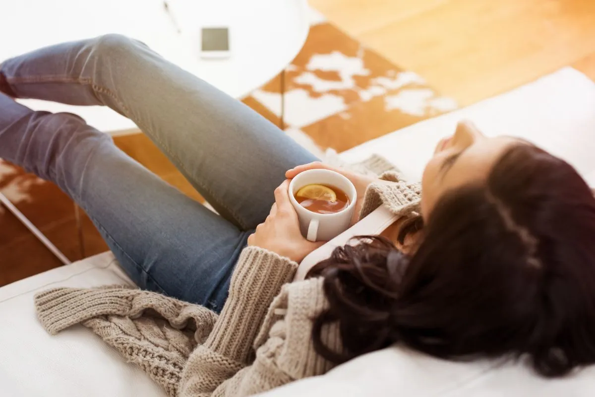woman relaxing on couch with tea