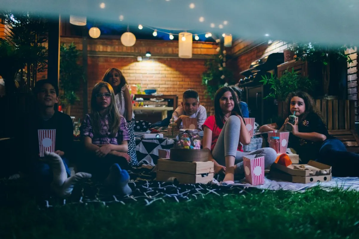 kid watching outdoor movie 