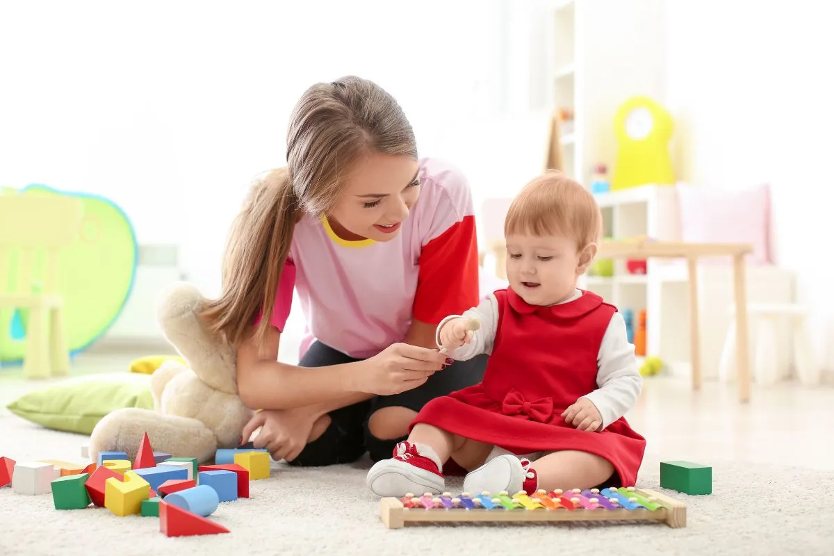 girl babysitting a baby
