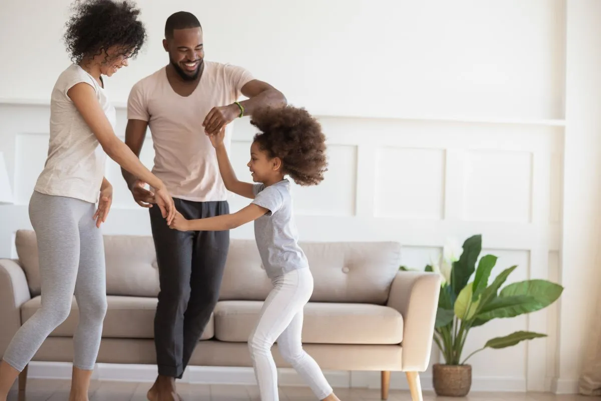 family dancing in the living room