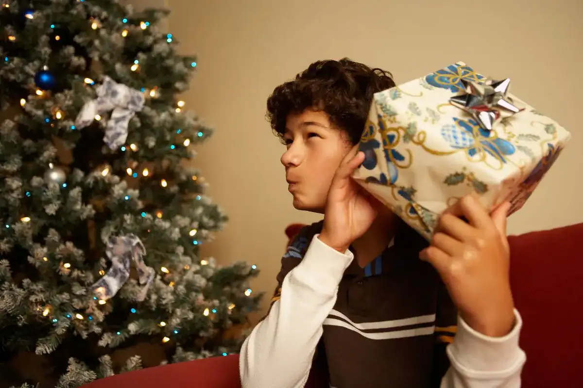 boy shaking a wrapped gift
